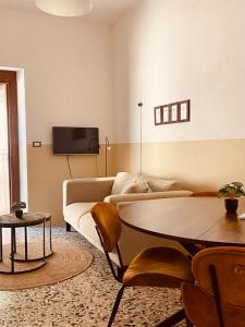 a living room with a couch and a table at Agriturismo Angeli Sognanti in Cossignano