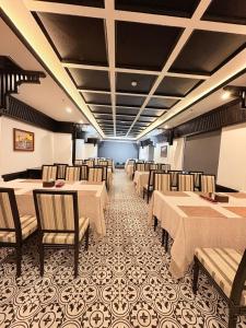 a dining room with tables and chairs in a room at Le Dung Hotel in Tam Kỳ