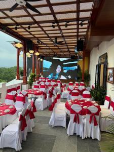 a group of tables and chairs with red and white bows at Le Dung Hotel in Tam Kỳ