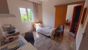 a bedroom with a bed and a table and chairs at Emilios Eleni studios in Nydri