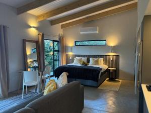 a bedroom with a bed and a table and a couch at The Sleep Studio in Kampersrus AH