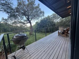 a bbq grill on the deck of a house at The Sleep Studio in Kampersrus AH