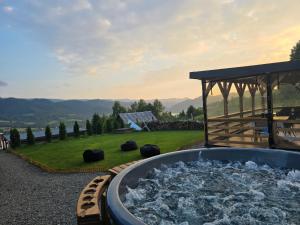 a hot tub on a patio with a gazebo at A Dream Colibita in Colibiţa