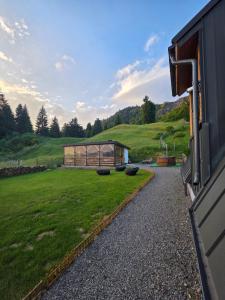 a building with a greenhouse in a field of grass at A Dream Colibita in Colibiţa
