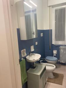 a blue bathroom with a sink and a toilet at Binario1 Lake View in Lierna +25 photos