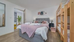 a bedroom with a large bed and a mirror at Apartman Grey in Jastrebarsko