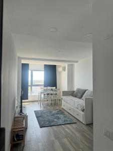 a living room with a bed and a dining room at Olimp sea view in Olimp