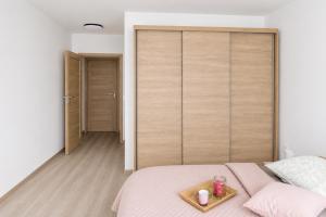 a bedroom with a bed with a tray on it at Na kopečku u lesa in Březová