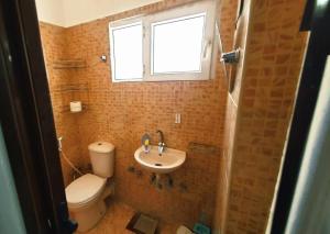 a bathroom with a sink and a toilet and a window at Villa in a compound with a rooftop in sheikh zayed in Sheikh Zayed +25 photos
