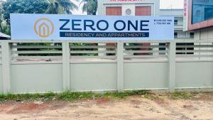 a sign on a fence in front of a building at Zero One Residency in Quilāndi