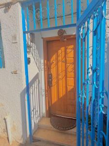 an entrance to a house with a blue gate at Villa in a compound with a rooftop in sheikh zayed in Sheikh Zayed