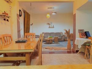 a living room with a table and a couch at Villa in a compound with a rooftop in sheikh zayed in Sheikh Zayed