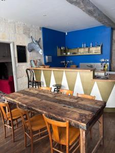 a dining room with a wooden table and chairs at Le Bon Appart in Angoulême