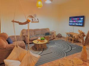 a living room with a couch and a tv at Villa in a compound with a rooftop in sheikh zayed in Sheikh Zayed