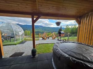 a backyard with a playground with a large window at Tiny House Colibita in Colibiţa