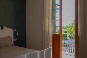 a bedroom with a bed next to a window at 108 B&B Valdobbiadene in Bigolino +4 photos