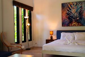 a bedroom with a bed and a painting on the wall at CocoCool Villas in Hinkong
