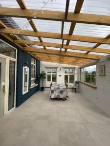 a large covered patio with a wooden ceiling at Mickeys Shed in Waterford