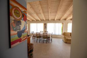 a dining room and living room with a table and chairs at 108 B&B Valdobbiadene in Bigolino