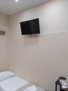 a room with a bed and a tv on a wall at Papale AIRPORT HOUSE in CTA