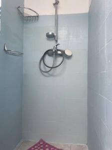 a shower with a hose on the wall of a bathroom at Casa Lucia Green Cottage in Corfu +1 photo