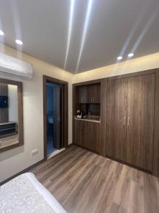 a bedroom with wooden cabinets and a bed at Lake Plaza Luxury Rooms in Borg El Arab