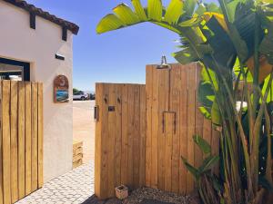 a wooden fence in front of a house at 3 Pepper Street by African Perfection in Jeffreys Bay