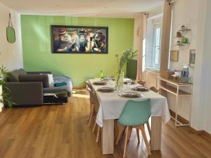 a living room with a table and a couch at L'échappée Belle "15 min Europa Park" in Rhinau