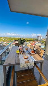 a table with plates of food on top of a balcony at Resort Living 1BR Corner Apartment with Balcony in Maribago