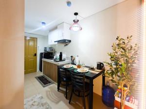 a kitchen with a table and chairs in a room at WanderDesk Living-Studio Unit with Workstation in Piapi +7 photos