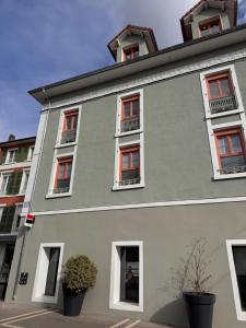 a building with red and white windows at Voiron centre - De Tassigny in Voiron