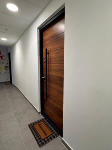 a wooden door in a hallway with a tile floor at Voiron centre - De Tassigny in Voiron +1 photo