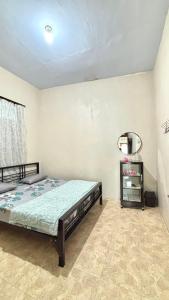 a bedroom with a bed in a room at HARMONI GUEST HOUSE tumpak sewu in Sumberbopong