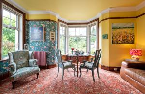 a living room with a table and chairs and a couch at The Mount B&B in Keswick