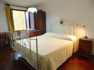 a bedroom with a bed with a white bedspread and a window at Apartment Poesia in Bagni di Lucca +41 photos