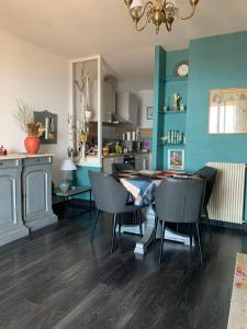 a dining room with blue walls and a table and chairs at Casa cesari in Ajaccio