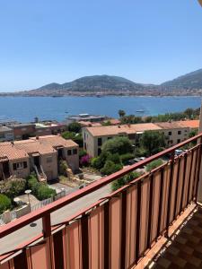 a balcony with a view of a city and the water at Casa cesari in Ajaccio