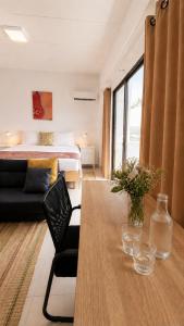 a living room with a bed and a table with a couch at Holiday House Kata & Karon Phuket Hotel in Kata Beach