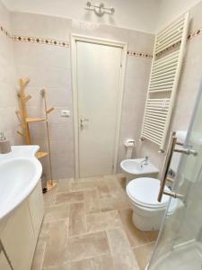 a bathroom with a toilet and a sink at La Casina di Perla in Viareggio +24 photos