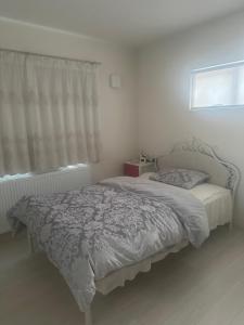 a bed in a bedroom with a window at any one in Chitose