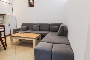 a living room with a couch and a table at Hotel Maresol Accommodation in Shëngjin