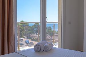 a bedroom with a bed with a view of the ocean at Hotel Maresol Accommodation in Shëngjin
