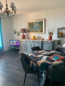a dining room with a table and chairs and a television at Casa cesari in Ajaccio