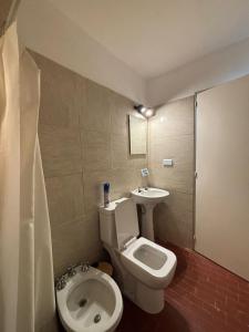 a bathroom with a toilet and a sink at Duplex Los Molles in Santa Rosa