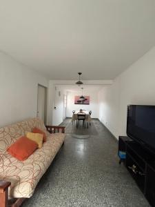 a living room with a couch and a table at Duplex Los Molles in Santa Rosa