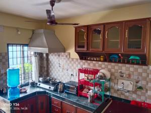 a kitchen with wooden cabinets and a counter top at Buddhi Boutique in Pokhara