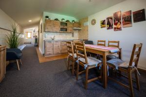 a kitchen and dining room with a table and chairs at Vinný sklep u Křížů in Milotice