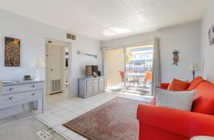 a living room with a red couch and a table at Sea Palm G in Fort Walton Beach