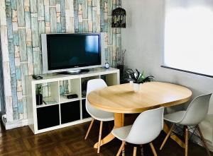 a dining room with a table and a television at Casa Urgueira in Pendilhe