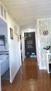 a hallway of a bedroom with a bed and a wooden floor at Casa Urgueira in Pendilhe